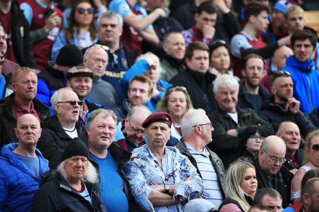 NORWICH, ENGLAND - APRIL 10: Fans of Burnley watch on during the Premier League match between Norwich City and Burnley at Carrow Road on April 10, 2022 in Norwich, England. (Photo by Stephen Pond/Getty Images)