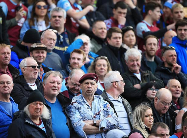 NORWICH, ENGLAND - APRIL 10: Fans of Burnley watch on during the Premier League match between Norwich City and Burnley at Carrow Road on April 10, 2022 in Norwich, England. (Photo by Stephen Pond/Getty Images)