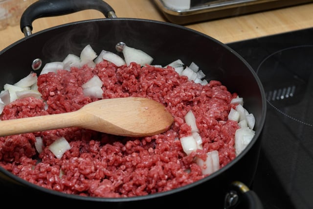 Add oil to a pan with meat and onion.