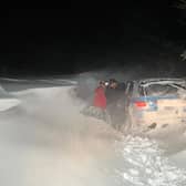 Mountain rescue teams had to "swim" through snow drifts to rescue the occupants of a stranded car who in east Lancashire (Credit: Rossendale & Pendle Mountain Rescue Team)