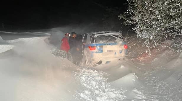 Mountain rescue teams had to "swim" through snow drifts to rescue the occupants of a stranded car who in east Lancashire (Credit: Rossendale & Pendle Mountain Rescue Team)