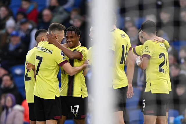 BRIGHTON, ENGLAND - DECEMBER 09: Wilson Odobert of Burnley celebrates with teammates after scoring their team's first goal during the Premier League match between Brighton & Hove Albion and Burnley FC at American Express Community Stadium on December 09, 2023 in Brighton, England. (Photo by Mike Hewitt/Getty Images)