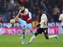 BURNLEY, ENGLAND - FEBRUARY 13: Ashley Westwood of Burnley is closed down by Naby Keita of Liverpool during the Premier League match between Burnley and Liverpool at Turf Moor on February 13, 2022 in Burnley, England. (Photo by Alex Livesey/Getty Images)