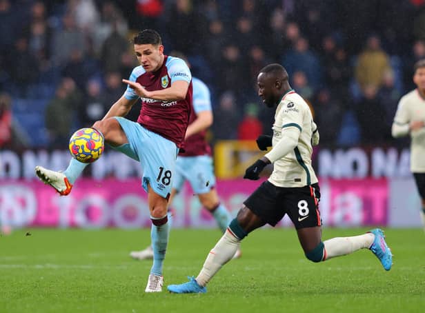 BURNLEY, ENGLAND - FEBRUARY 13: Ashley Westwood of Burnley is closed down by Naby Keita of Liverpool during the Premier League match between Burnley and Liverpool at Turf Moor on February 13, 2022 in Burnley, England. (Photo by Alex Livesey/Getty Images)