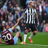 BURNLEY, ENGLAND - MAY 04:  Bruno Guimaraes of Newcastle United sportingly helps up Burnley player Lorenz  Assignon during the Premier League match between Burnley FC and Newcastle United at Turf Moor on May 04, 2024 in Burnley, England. (Photo by Stu Forster/Getty Images)