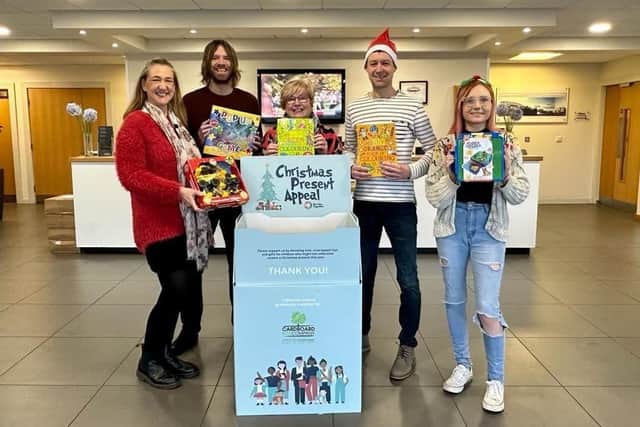 Ready to receive gifts for this year's Christmas Present Appeal are (from left to right) Nicola Larnach, the co-ordinator of Burnley Together,  Burnley Express editor John Deehan, and reporters Sue Plunkett, Dominic Collis and Laura Lomgworth.