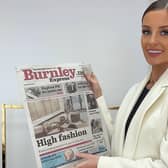 Briony shows off the front page of the Burnley Express announcing the opening of her first shop in her hometown