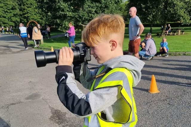 George Webster (12), volunteer photographer at Burnley parkrun in Towneley Park.