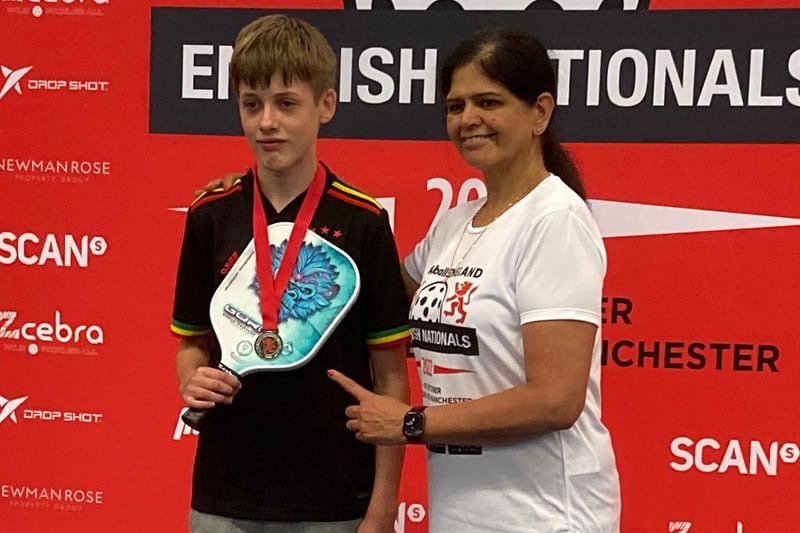 Junior player Oscar Riding receiving a silver medal at a pickleball tournament