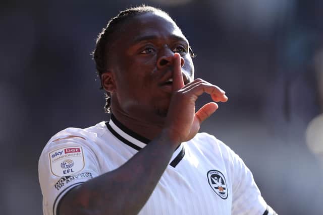 CARDIFF, WALES - APRIL 02: Michael Obafemi of Swansea City interacts with the Cardiff City fans as Hannes Wolf ( not pictured ) celebrates scoring their side's third goal during the Sky Bet Championship match between Cardiff City and Swansea City at Cardiff City Stadium on April 02, 2022 in Cardiff, Wales. (Photo by Ryan Hiscott/Getty Images)
