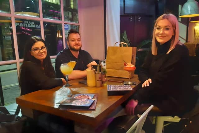 Three happy diners at Illuminati in Burnley