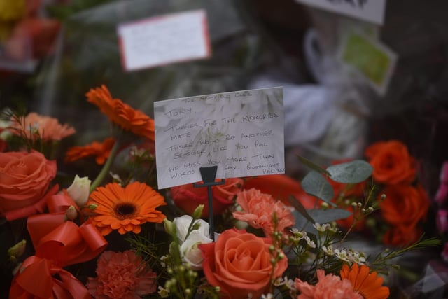 Orange flowers left by those paying their respects to Mr Johnson.
