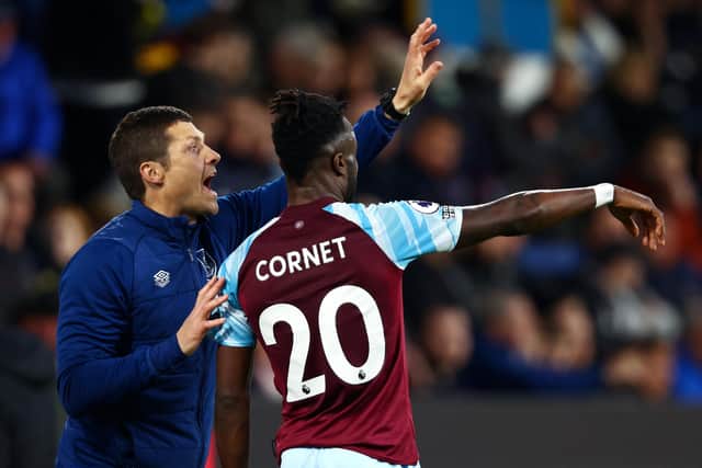 BURNLEY, ENGLAND - APRIL 21: Michael Jackson, Caretaker Manager of Burnley speaks with Maxwel Cornet of Burnley during the Premier League match between Burnley and Southampton at Turf Moor on April 21, 2022 in Burnley, England. (Photo by Clive Brunskill/Getty Images)