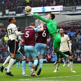 BURNLEY, ENGLAND - FEBRUARY 13: Nick Pope of Burnley punches the ball away from Joel Matip of Liverpool during the Premier League match between Burnley and Liverpool at Turf Moor on February 13, 2022 in Burnley, England. (Photo by Alex Livesey/Getty Images)