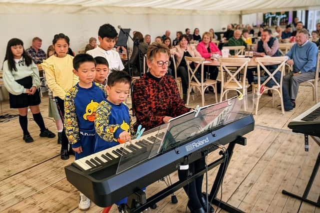 Music school teacher Janet Westmoreland with some of her students who performed at a charity concert at Simply Fields in Hurstwood