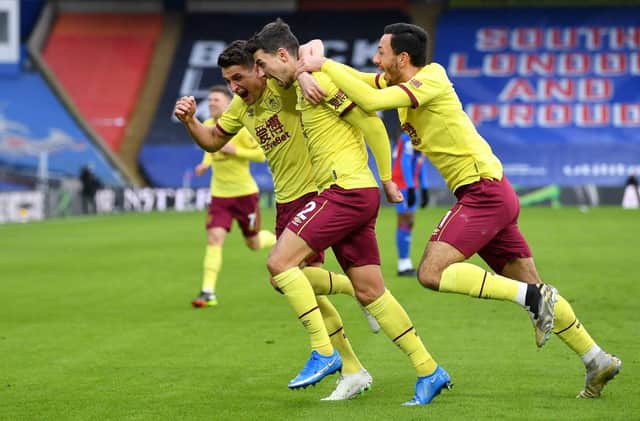 Matthew Lowton of Burnley celebrates with teammates Ashley Westwood and Dwight McNeil after scoring his team's third goal during the Premier League match between Crystal Palace and Burnley. (Photo by Justin Setterfield/Getty Images)