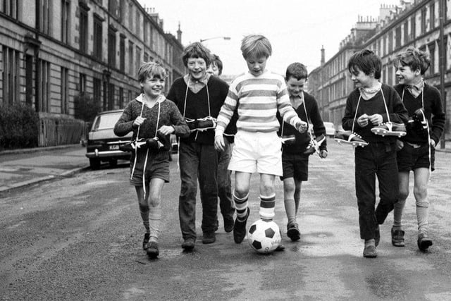 Little boys show off their Xmas presents (including new football boots, a football and a Celtic strip) in McCulloch Street, Pollokshields Glasgow in December 1970.