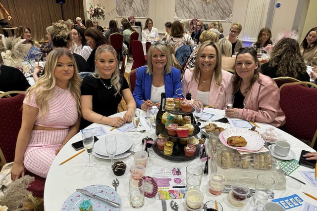 People attending an afternoon tea fundraiser hosted by Michelle Williamson in aid of Pendleside Hospice and The Brain Tumour Charity.