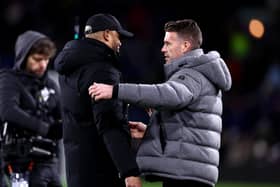 BURNLEY, ENGLAND - JANUARY 12: Vincent Kompany, Manager of Burnley, (L) and Rob Edwards, Manager of Luton Town, (R) interact prior to kick-off ahead of the Premier League match between Burnley FC and Luton Town at Turf Moor on January 12, 2024 in Burnley, England. (Photo by Naomi Baker/Getty Images)