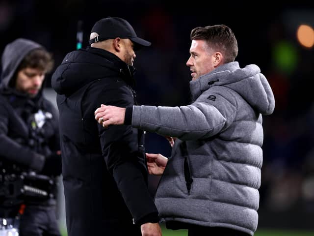 BURNLEY, ENGLAND - JANUARY 12: Vincent Kompany, Manager of Burnley, (L) and Rob Edwards, Manager of Luton Town, (R) interact prior to kick-off ahead of the Premier League match between Burnley FC and Luton Town at Turf Moor on January 12, 2024 in Burnley, England. (Photo by Naomi Baker/Getty Images)