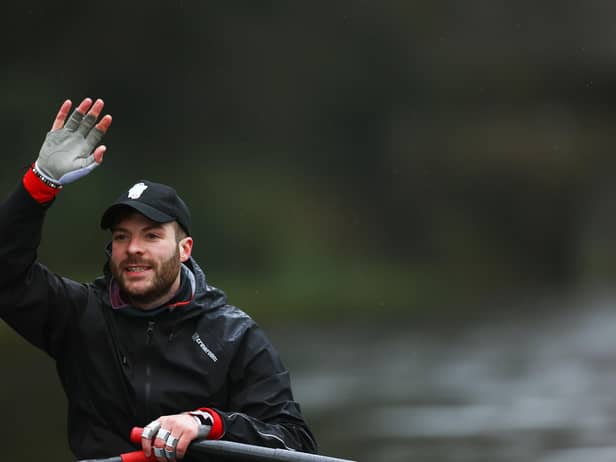 Jordan North manages to raise a a smile as he waves to cheering supporters on his epic 100 mile rowing challenge