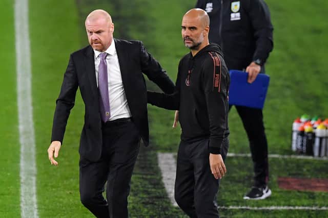 Burnley's English manager Sean Dyche (L) and Manchester City's Spanish manager Pep Guardiola (R) after the English League Cup fourth round football match between Burnley and Manchester City at Turf Moor in Burnley, north west England on September 30, 2020.