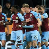 Burnley's Irish defender Nathan Collins (centre right) celebrates with teammates after scoring the opening goal of the English Premier League football match between Burnley and Everton at Turf Moor in Burnley, north west England on April 6, 2022.