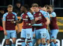 Burnley's Irish defender Nathan Collins (centre right) celebrates with teammates after scoring the opening goal of the English Premier League football match between Burnley and Everton at Turf Moor in Burnley, north west England on April 6, 2022.