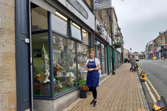 Amanda Hanson outside her shop, Sweet William florist in Burnley's Standish Street. Amanda and other traders claim their trade has been severely affected by roadworks to repair the Curzon Street bridge and also work that is taking place on the new Pioneer Place development