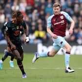BURNLEY, ENGLAND - MARCH 05: Nathan Collins of Burnley runs with the ball from Trevoh Chalobah of Chelsea during the Premier League match between Burnley and Chelsea at Turf Moor on March 05, 2022 in Burnley, England.