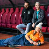 (Lft to right) Ben Bottomley from Burnley FC in the Community, Leah Hooper from Pendleside Hospice and  (front) Lisa Durkin from Safenet at the launch of the Sleep on The Turf 2022. Photo: Kelvin Stuttard