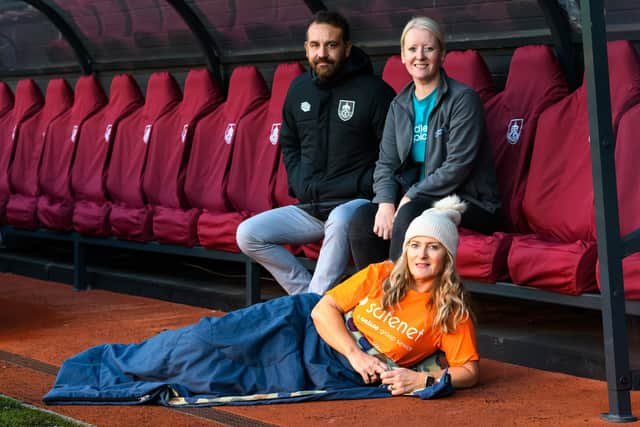 (Lft to right) Ben Bottomley from Burnley FC in the Community, Leah Hooper from Pendleside Hospice and  (front) Lisa Durkin from Safenet at the launch of the Sleep on The Turf 2022. Photo: Kelvin Stuttard