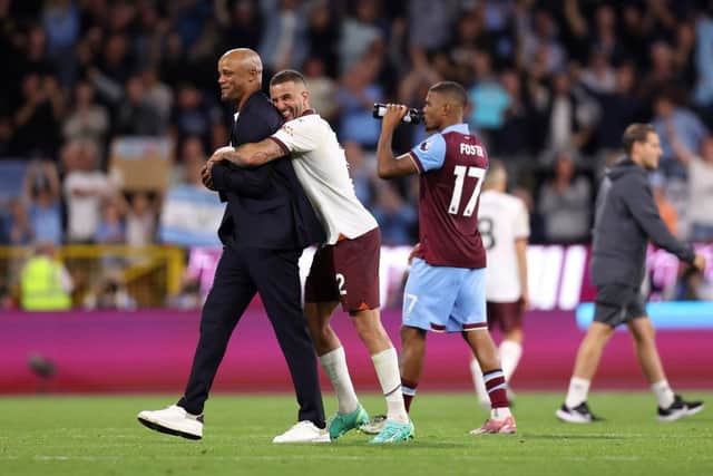 BURNLEY, ENGLAND - AUGUST 11: Vincent Kompany, Manager of Burnley, is embraced by Kyle Walker of Manchester City after the Premier League match between Burnley FC and Manchester City at Turf Moor on August 11, 2023 in Burnley, England. (Photo by Nathan Stirk/Getty Images)