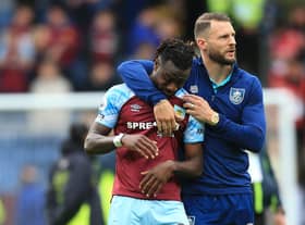 Burnley's Ivorian defender Maxwel Cornet (L) is consoled by Burnley's Dutch defender Erik Pieters on the pitch after the English Premier League football match between Burnley and Newcastle United at Turf Moor in Burnley, north west England on May 22, 2022. - Burnley were relegated from the Premier League on Sunday's final day of the 2021/22 season. The Clarets had to better the result of relegation rivals Leeds to extend their five-season stay in English football's top flight but lost as Leeds won away at Brentford.
 - RESTRICTED TO EDITORIAL USE. No use with unauthorized audio, video, data, fixture lists, club/league logos or 'live' services. Online in-match use limited to 120 images. An additional 40 images may be used in extra time. No video emulation. Social media in-match use limited to 120 images. An additional 40 images may be used in extra time. No use in betting publications, games or single club/league/player publications. (Photo by Lindsey Parnaby / AFP) / RESTRICTED TO EDITORIAL USE. No use with unauthorized audio, video, data, fixture lists, club/league logos or 'live' services. Online in-match use limited to 120 images. An additional 40 images may be used in extra time. No video emulation. Social media in-match use limited to 120 images. An additional 40 images may be used in extra time. No use in betting publications, games or single club/league/player publications. / RESTRICTED TO EDITORIAL USE. No use with unauthorized audio, video, data, fixture lists, club/league logos or 'live' services. Online in-match use limited to 120 images. An additional 40 images may be used in extra time. No video emulation. Social media in-match use limited to 120 images. An additional 40 images may be used in extra time. No use in betting publications, games or single club/league/player publications. (Photo by LINDSEY PARNABY/AFP via Getty Images)