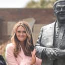 Charlotte Dawson with the statue of her dad Les Dawson statue in St Annes. In this photo Charlotte is pulling the same facial expression her dad was so famously loved for