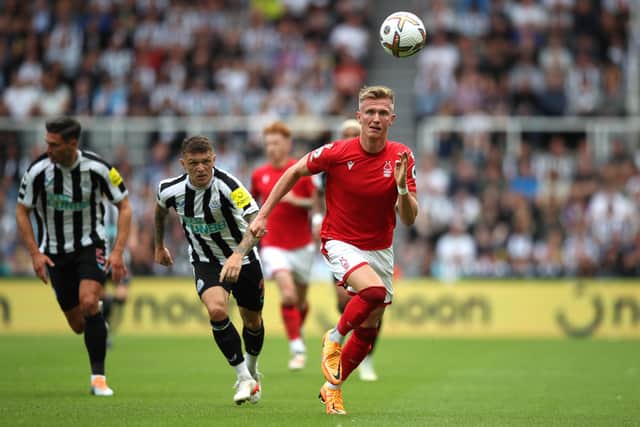 NEWCASTLE UPON TYNE, ENGLAND - AUGUST 06: Sam Surridge of Nottingham Forest is challenged by Kieran Trippier of  Newcastle United during the Premier League match between Newcastle United and Nottingham Forest at St. James Park on August 06, 2022 in Newcastle upon Tyne, England. (Photo by Jan Kruger/Getty Images)