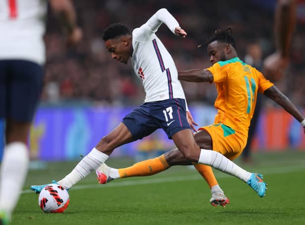LONDON, ENGLAND - MARCH 29: Kyle Walker-Peters of England is tackled by Maxwel Cornet of Cote D'Ivoire during the international friendly match between England and Cote D'Ivoire at Wembley Stadium on March 29, 2022 in London, England. (Photo by Catherine Ivill/Getty Images)