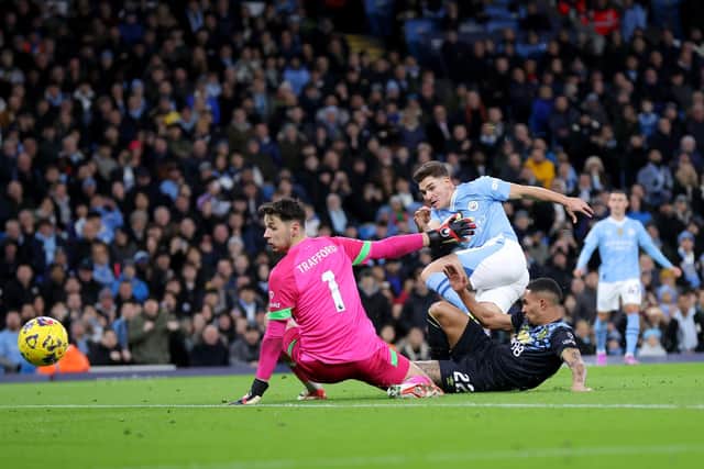 MANCHESTER, ENGLAND - JANUARY 31: Julian Alvarez of Manchester City scores his team's second goal past James Trafford of Burnley during the Premier League match between Manchester City and Burnley FC at Etihad Stadium on January 31, 2024 in Manchester, England. (Photo by Alex Livesey/Getty Images)