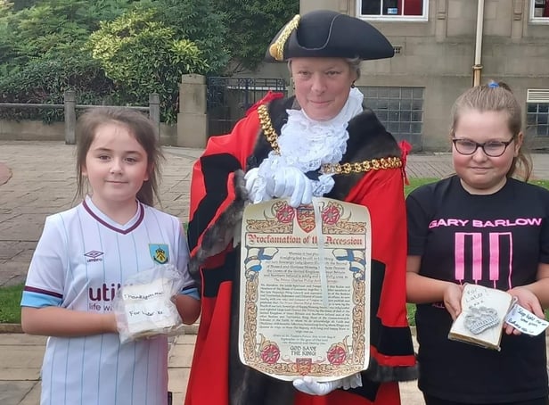 Bethany Marshall (right) with her marmalade sandwich tribute for the Queen, with her best pal Daisie Lumsden and the Mayor of Burnley at the Royal proclamation reading this afternoon.