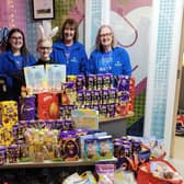George Greenwood (nine) hands over the Easter treats he bought for children spending the holiday in hospital to the charity ELHT&Me
