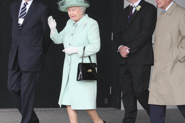The Queen waves to the crowds as she leaves Burnley College.