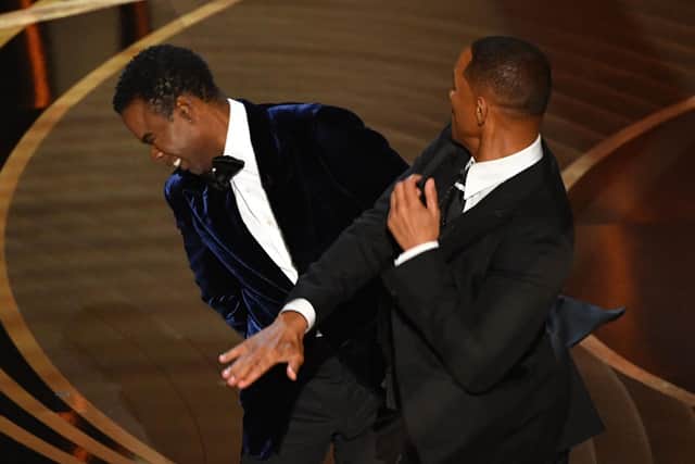 Will Smith slaps US actor Chris Rock onstage during the 94th Oscars at the Dolby Theatre in Hollywood, California on March 27, 2022. (Photo by Robyn Beck / AFP) (Photo by ROBYN BECK/AFP via Getty Images)
