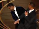 Will Smith slaps US actor Chris Rock onstage during the 94th Oscars at the Dolby Theatre in Hollywood, California on March 27, 2022. (Photo by Robyn Beck / AFP) (Photo by ROBYN BECK/AFP via Getty Images)