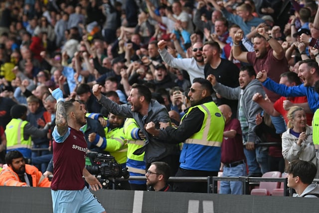 Burnley's English midfielder Josh Brownhill (L) celebrates in front of supporters after scoring their second goal during the English Premier League football match between Watford and Burnley at Vicarage Road Stadium in Watford, north-west of London, on April 30, 2022.