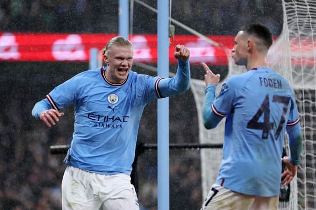 MANCHESTER, ENGLAND - MARCH 18: Erling Haaland of Manchester City celebrates with teammate Phil Foden after scoring the team's second goal during the Emirates FA Cup Quarter Final match between Manchester City and Burnley at Etihad Stadium on March 18, 2023 in Manchester, England. (Photo by Clive Brunskill/Getty Images)