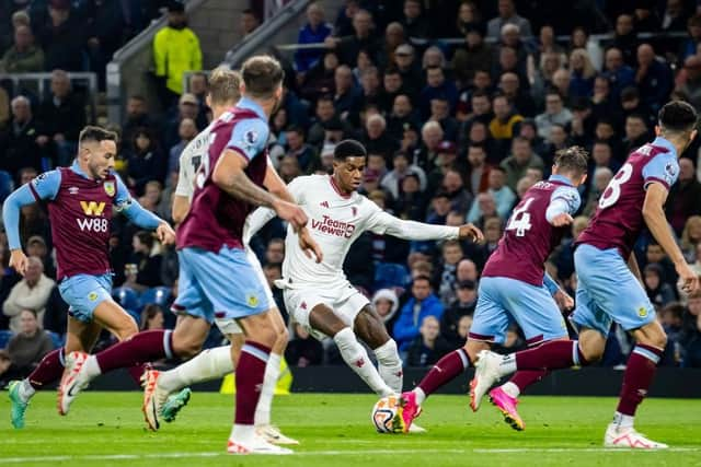 BURNLEY, ENGLAND - SEPTEMBER 23: Marcus Rashford of Manchester United challenges Connor Roberts of Burnley FC for the ball during the Premier League match between Burnley FC and Manchester United at Turf Moor on September 23, 2023 in Burnley, England. (Photo by Ash Donelon/Manchester United via Getty Images)