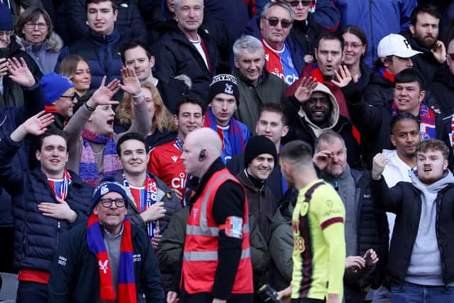 LONDON, ENGLAND - FEBRUARY 24: Crystal Palace fans wave as Josh Brownhill of Burnley leaves the pitch after being shown a red card during the Premier League match between Crystal Palace and Burnley FC at Selhurst Park on February 24, 2024 in London, England. (Photo by Richard Heathcote/Getty Images)