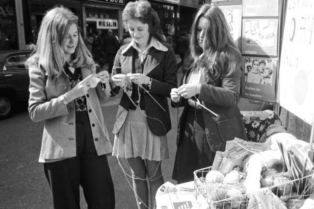 Three girls knitting at the Be a Knit for Oxfam campaign in Buchanan Street Glasgow, August 1974.
