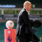 NORWICH, ENGLAND - APRIL 10: Burnley Manager Sean Dyche passes the match ball ahead of the Premier League match between Norwich City and Burnley at Carrow Road on April 10, 2022 in Norwich, England. (Photo by Stephen Pond/Getty Images)