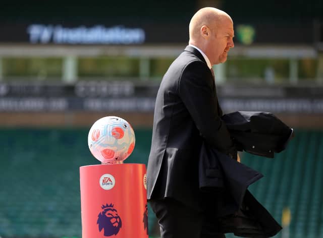 NORWICH, ENGLAND - APRIL 10: Burnley Manager Sean Dyche passes the match ball ahead of the Premier League match between Norwich City and Burnley at Carrow Road on April 10, 2022 in Norwich, England. (Photo by Stephen Pond/Getty Images)